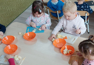 Dzieci przygotowują sałatkę warzywną